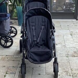 Black and Gray Tandem Stroller with Adjustable Canopies and Lightweight Frame